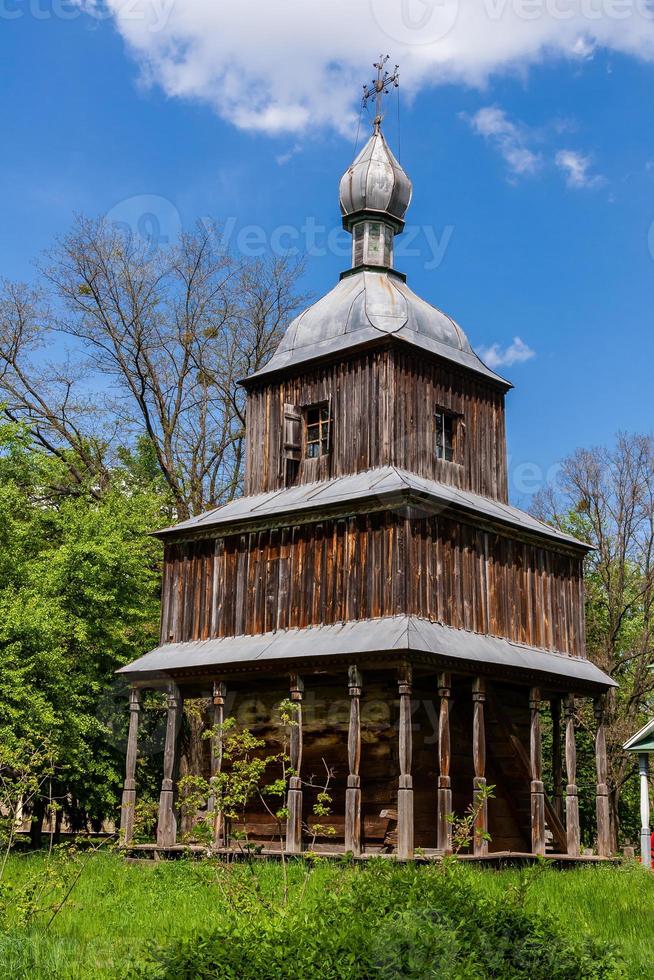 Ancient wooden church on a background of blue sky photo