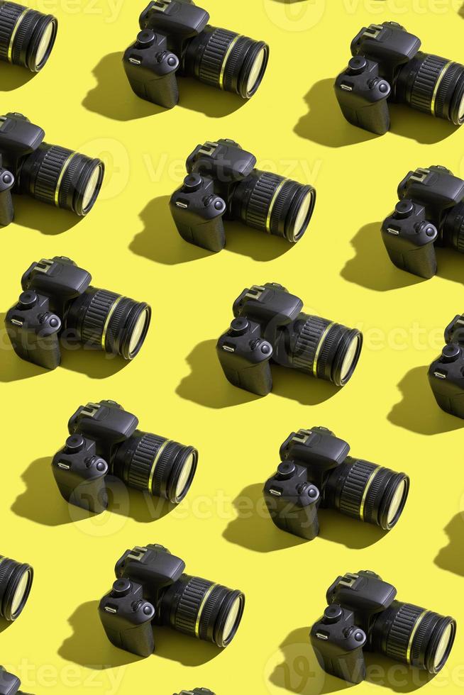 Pattern from many photo cameras on colored background. World Photography Day concept