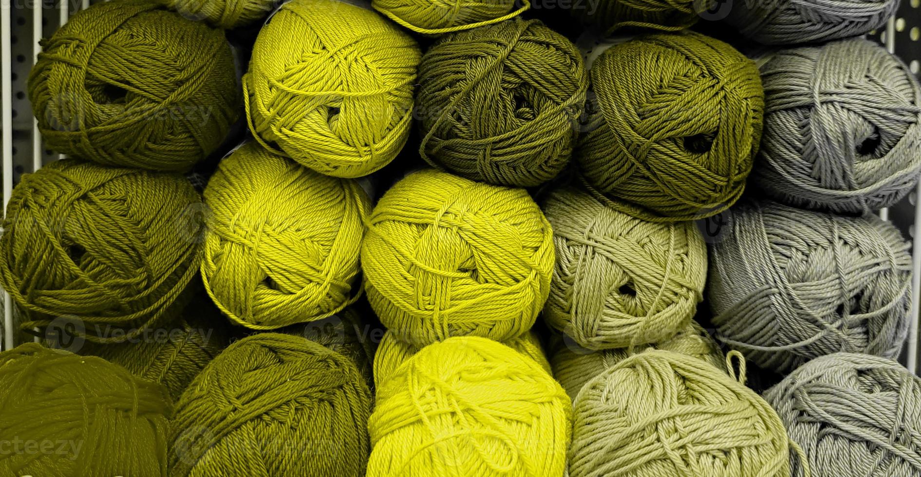 colorido de lana de bolas de hilo en una tienda de telas. fondo de hilo acrílico coloreado. madejas de primer plano de hilo. materiales para costura, para tejer y ganchillo. foto