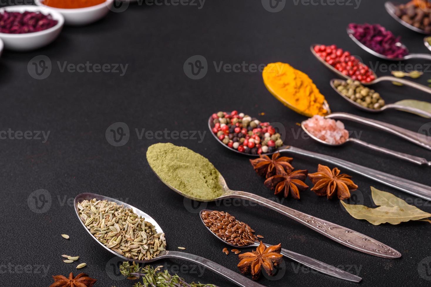 Composition consisting of variations of spices in white bowls and metal spoons photo