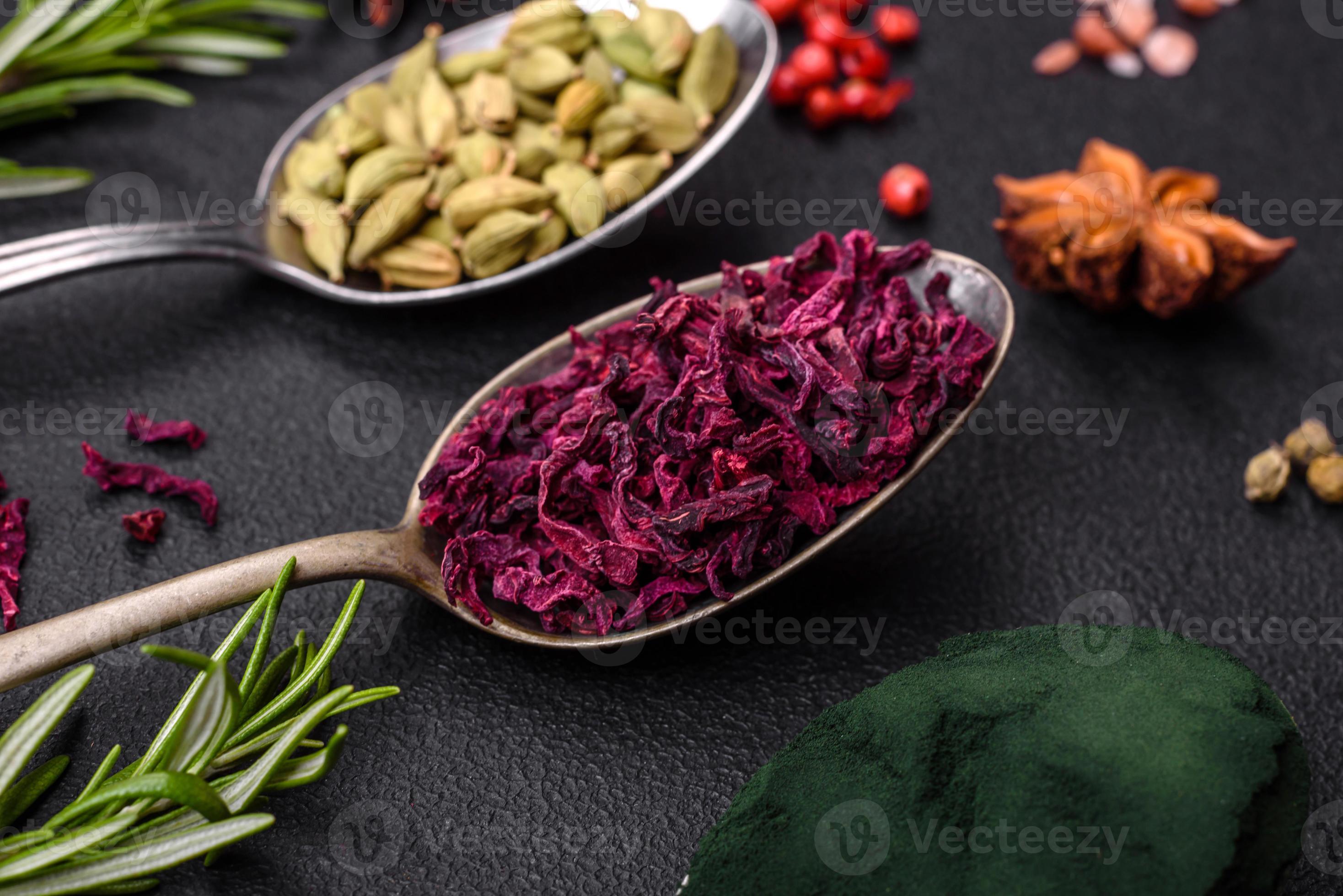 Variation of spices in metal spoons paprika, turmeric, cardamom, a ...