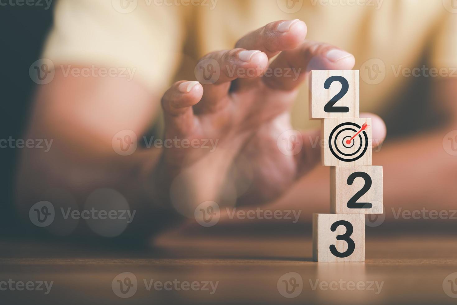 businessman and wooden block,Setting business goals and focused concepts, Organizational growth and objectives, marketing strategy planning,New Year 2023 Beginning Concept photo