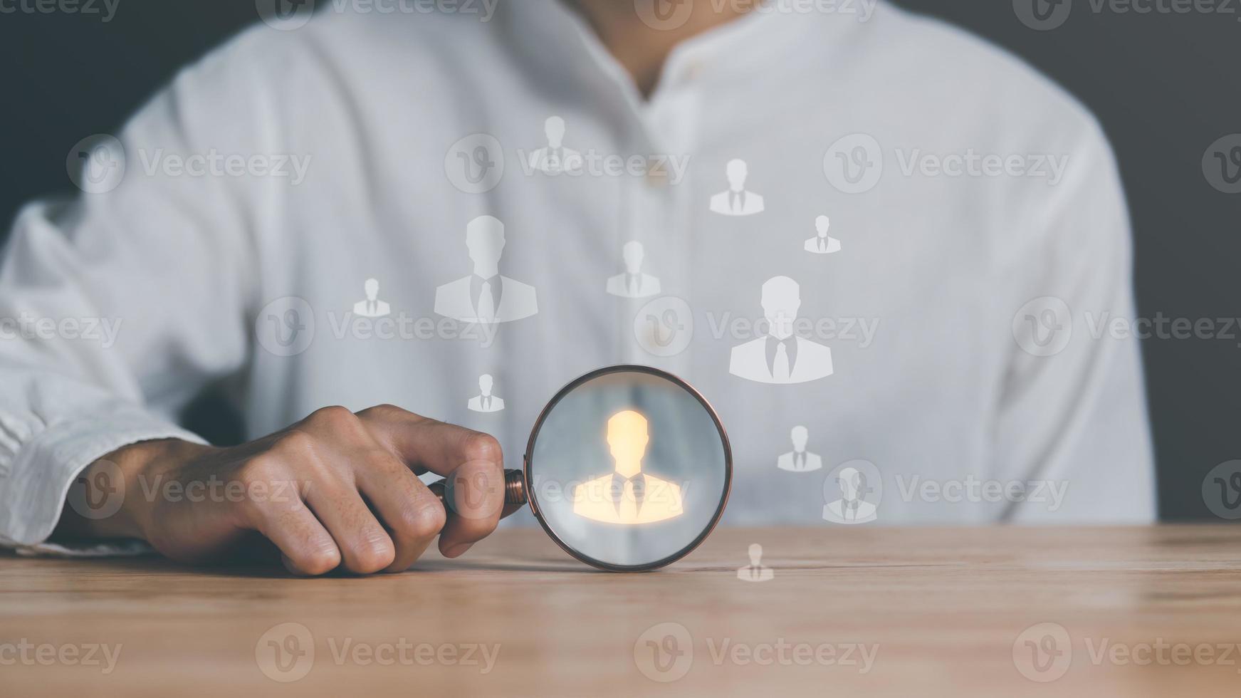 HRM ,Human Resource Management ,Strategic planning for success through people business development concept by choosing professional leaders employee competency Teamwork,man holding a magnifying glass photo