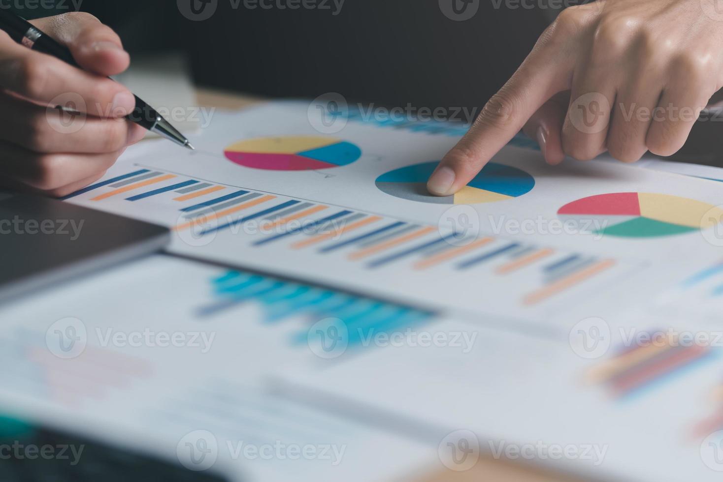 Business people read business statistics chart reports, to analyze and improve corporate strategy, manage financial and marketing documents, update annual budget accounts, company growth data. photo