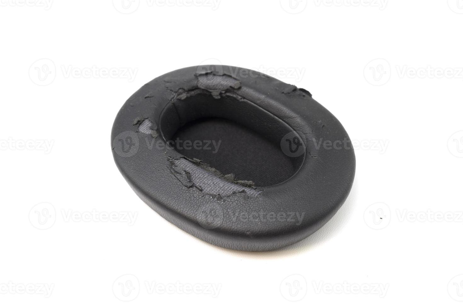 broken headphone pad from frequent use isolated on a white background. photo