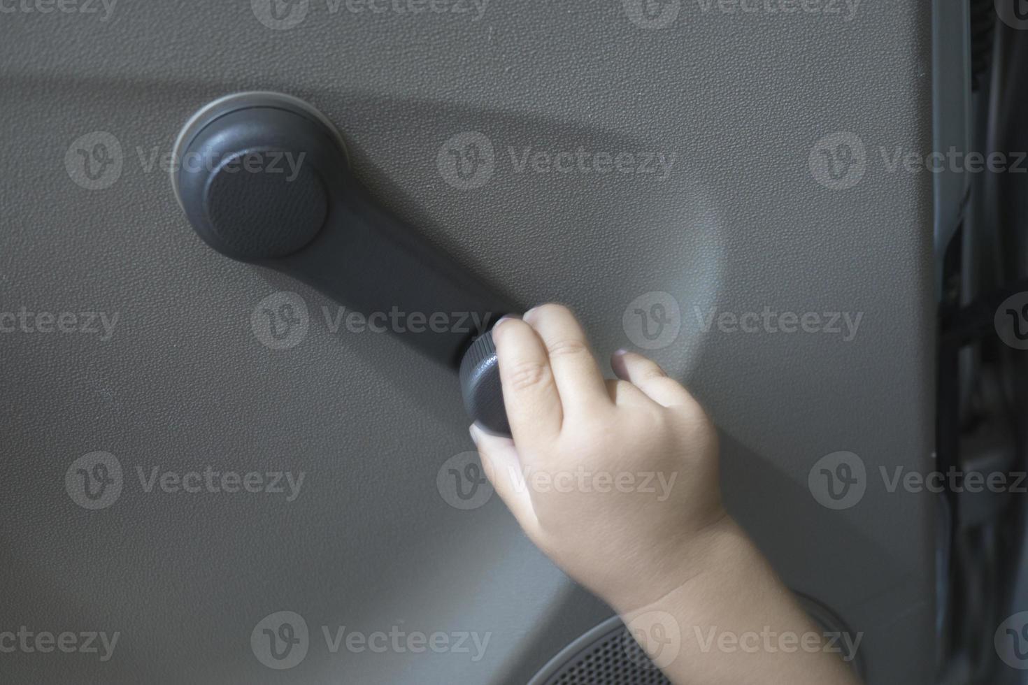 Close Up Non Electric Manual Car Window Hand Crank With Baby Hands Close Up Non Electric Manual Car Window Hand Crank With Baby Hands