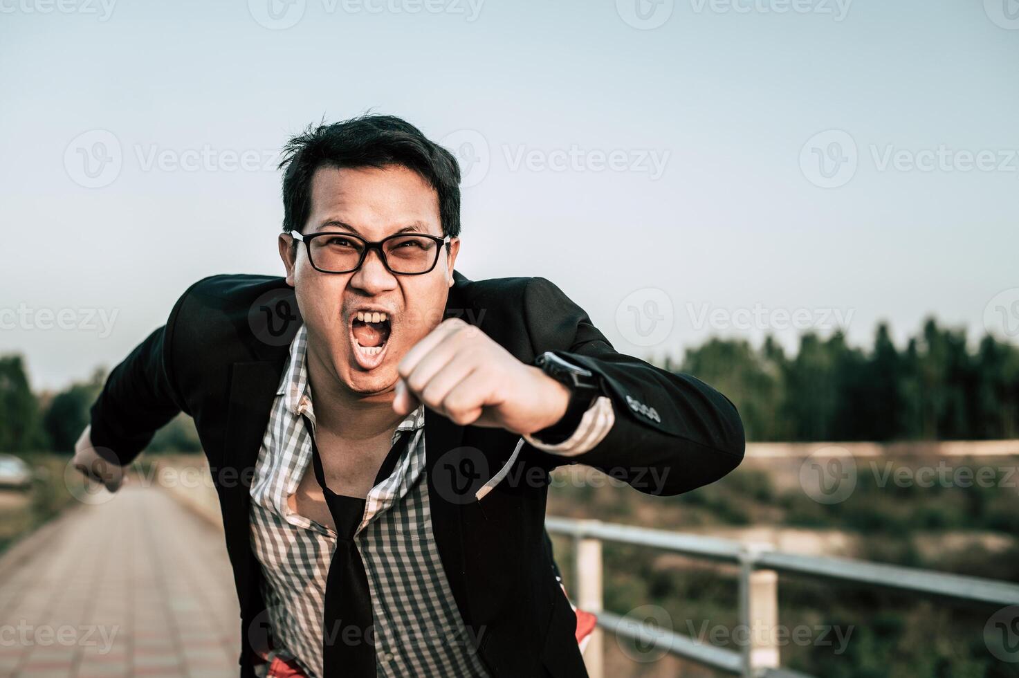 Young funny businessman man in crazy and funny manner posture photo