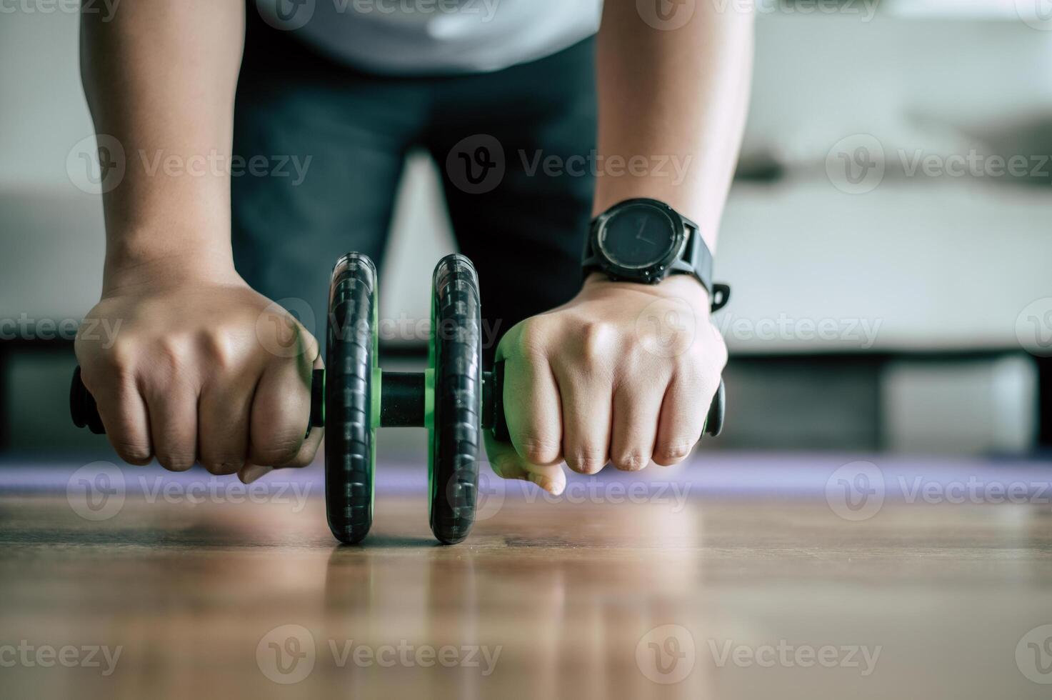 Young fat man workout with ABS hand-roller photo