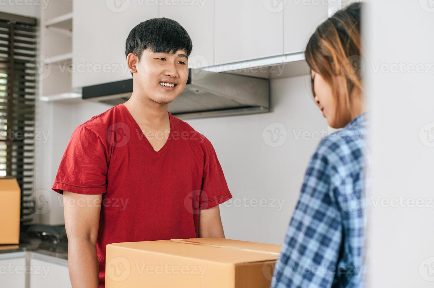 Young couple moving package into new house photo