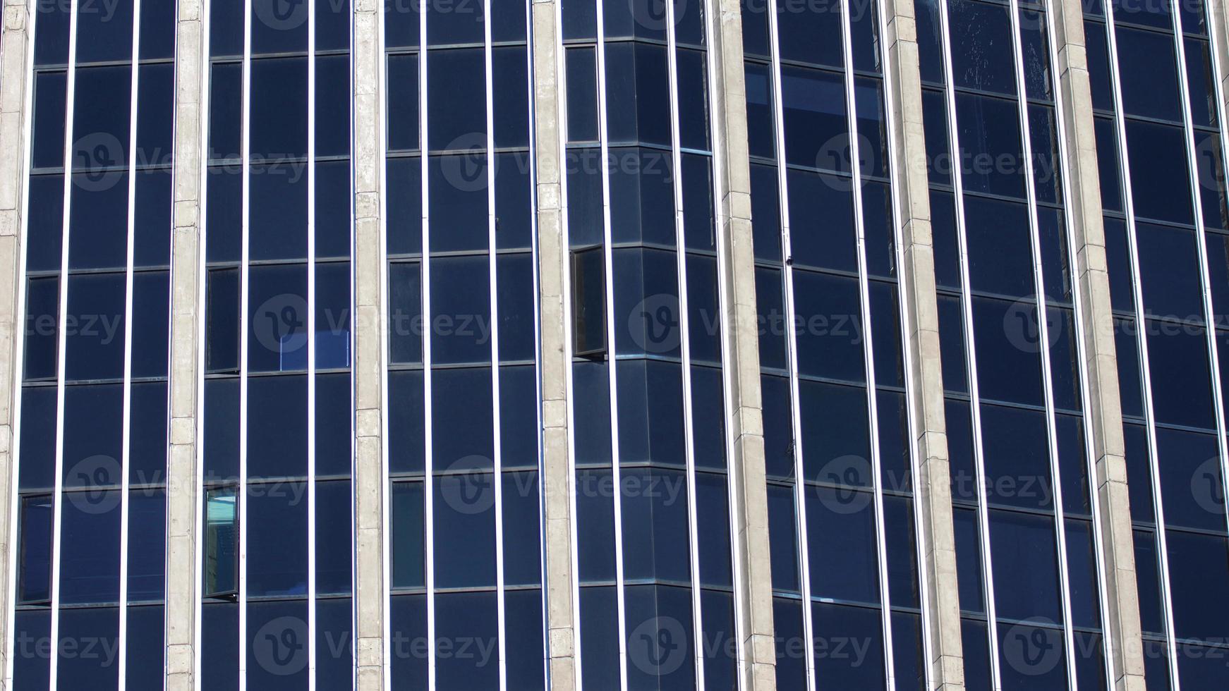 Modern building with blue glass windows reflected sky. Background in horizontal format photo