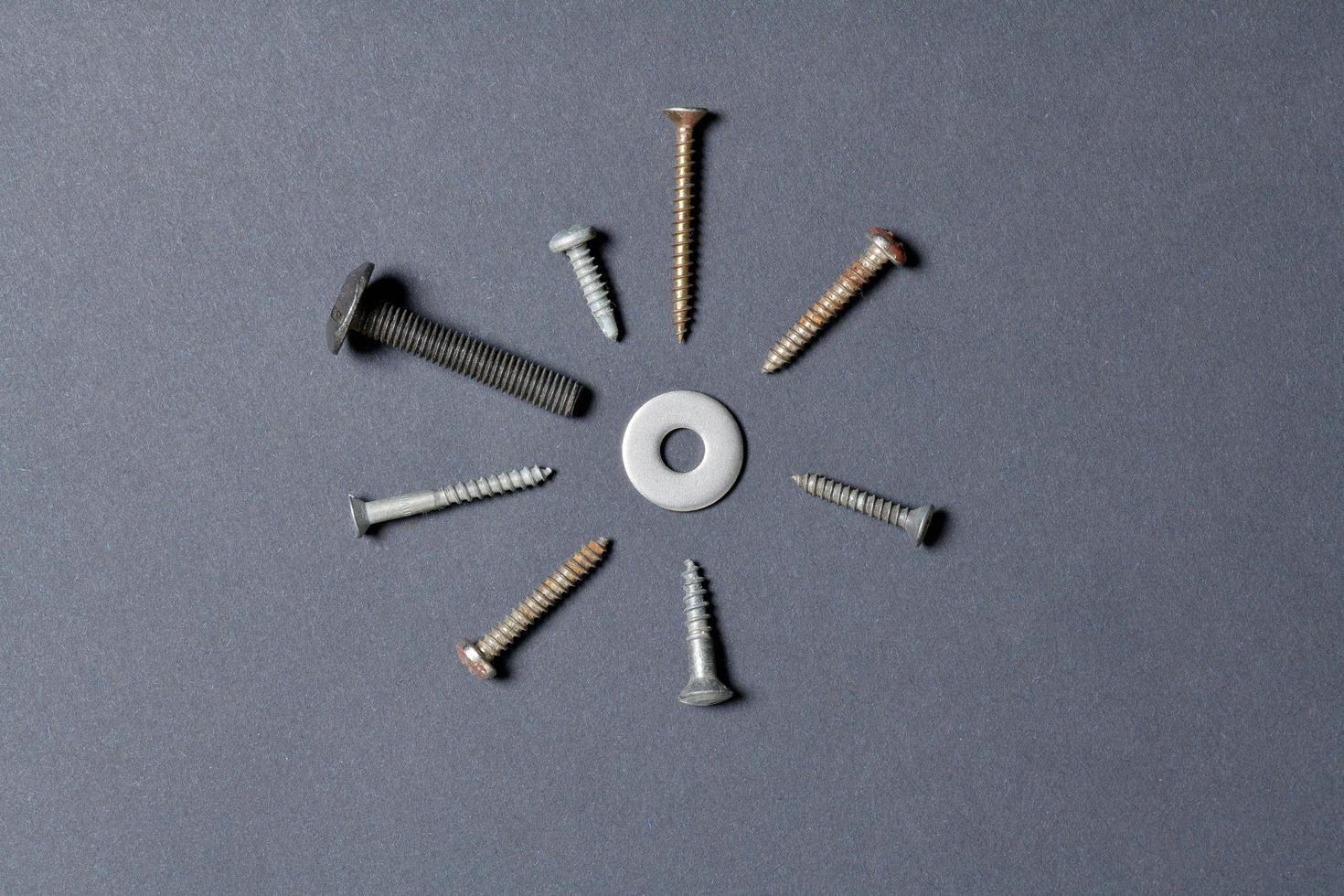Top view of screws isolated on black paper background photo