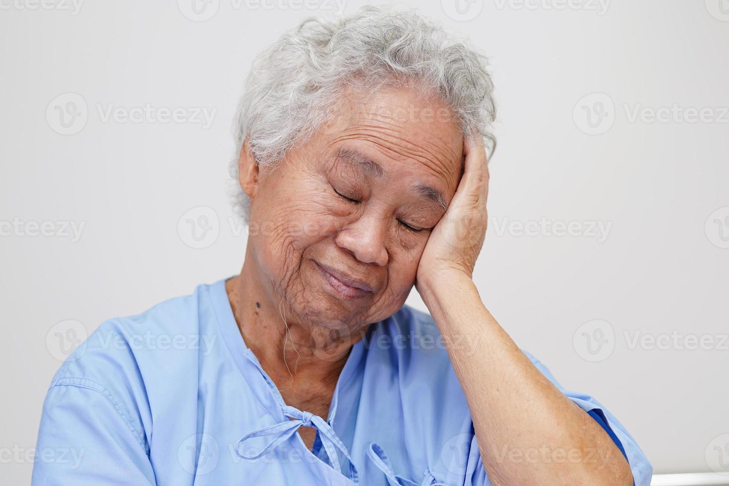 Asian elder senior woman patient suffering from headache with alone in hospital. photo