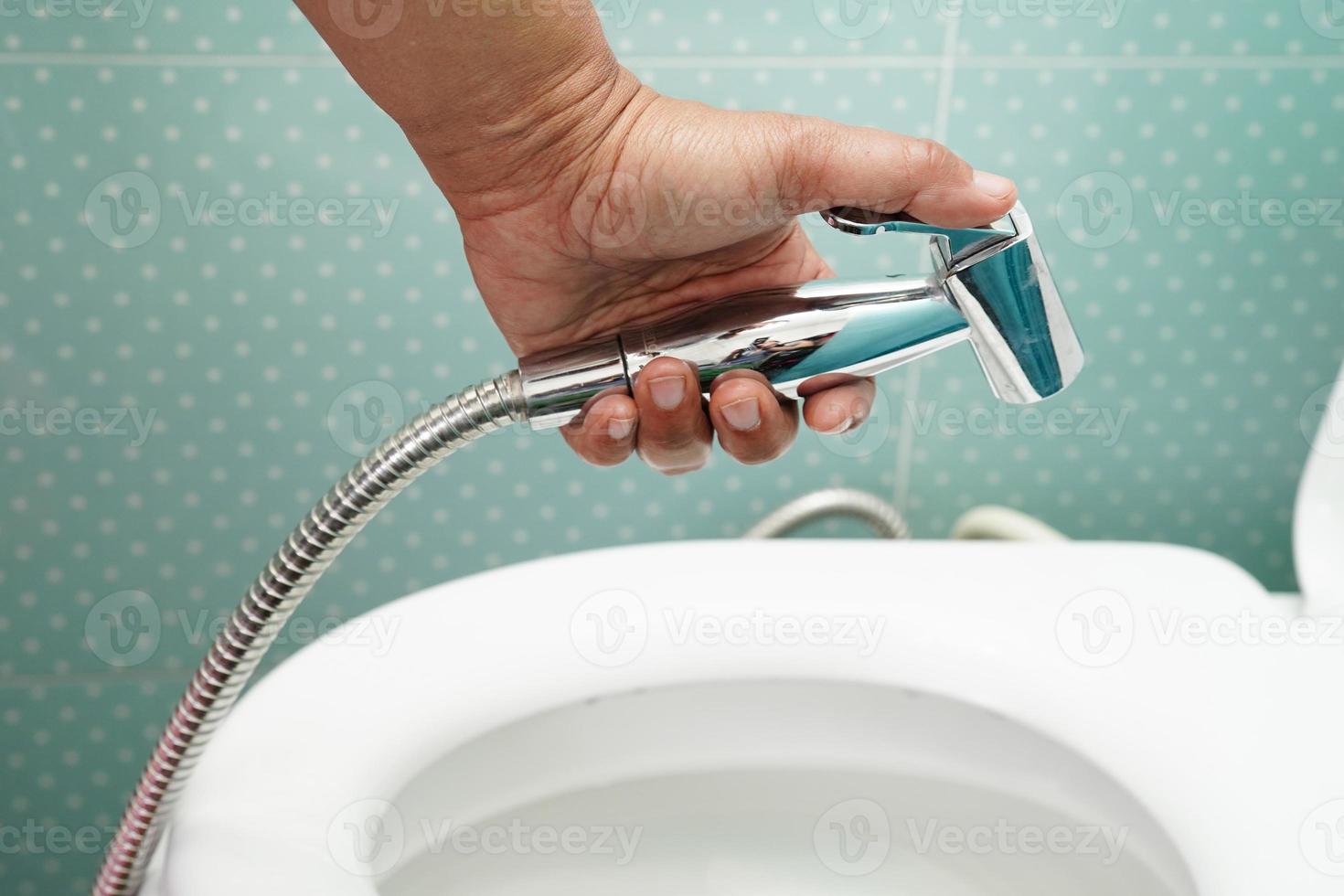 Asian woman patient use toilet support rail in bathroom, handrail safety grab bar, security in nursing hospital. photo