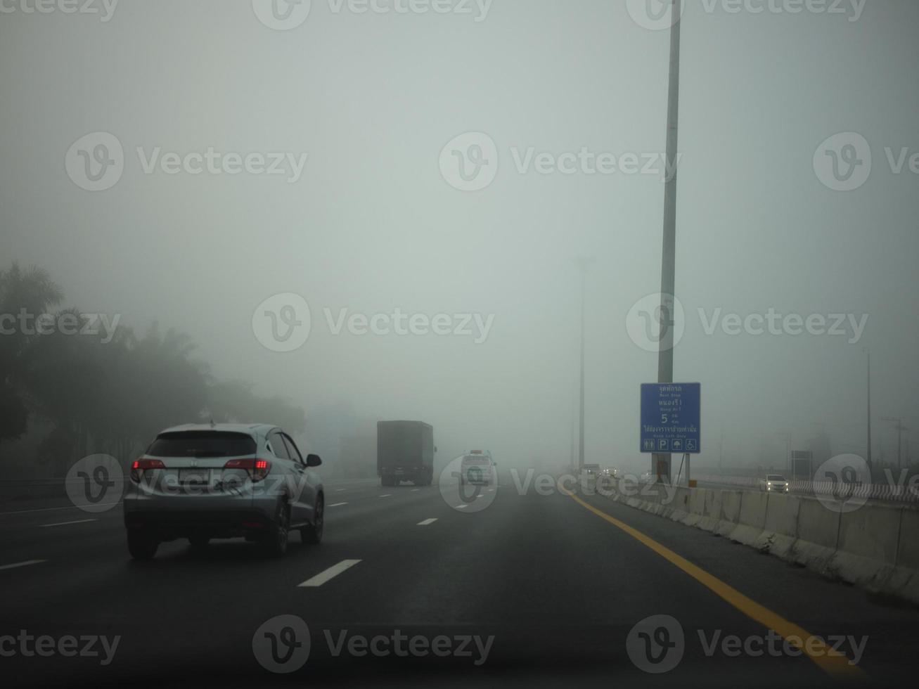 Road in the fog, sign mention keep distance for Motorway-t7.svg photo