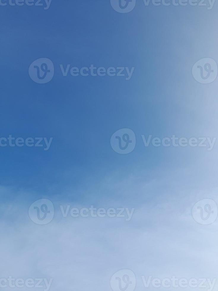 Beautiful white clouds on deep blue sky background. Elegant blue sky picture in daylight. Large bright soft fluffy clouds are cover the entire blue sky. photo