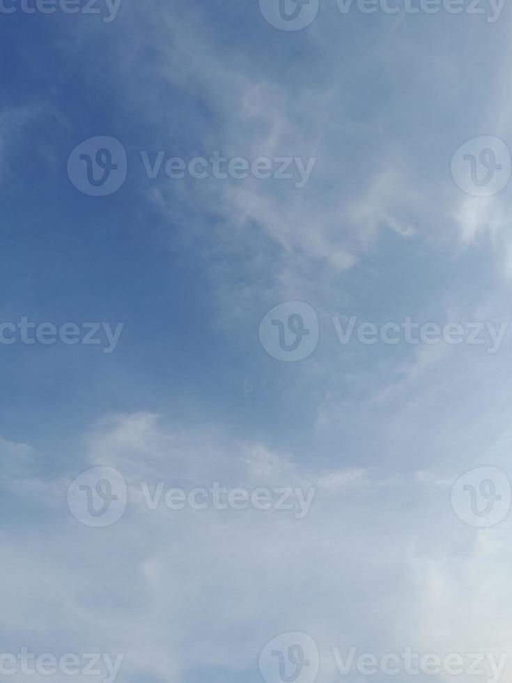 Beautiful white clouds on deep blue sky background. Elegant blue sky picture in daylight. Large bright soft fluffy clouds are cover the entire blue sky. photo