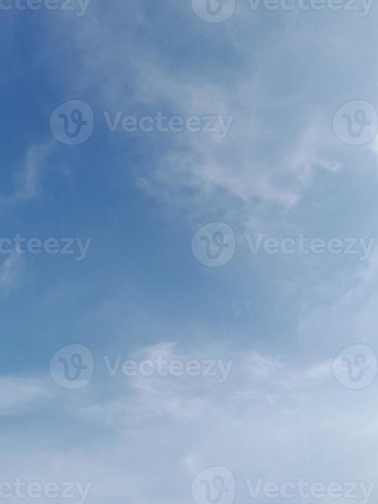 Beautiful white clouds on deep blue sky background. Elegant blue sky picture in daylight. Large bright soft fluffy clouds are cover the entire blue sky. photo