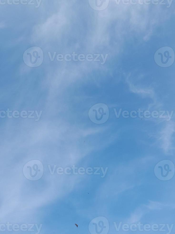 Beautiful white clouds on deep blue sky background. Elegant blue sky picture in daylight. Large bright soft fluffy clouds are cover the entire blue sky. photo