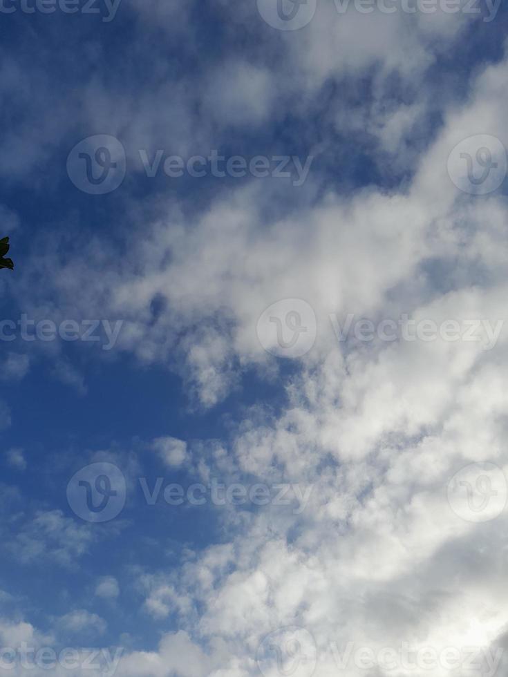 Beautiful white clouds on deep blue sky background. Large bright soft fluffy clouds are cover the entire blue sky. photo