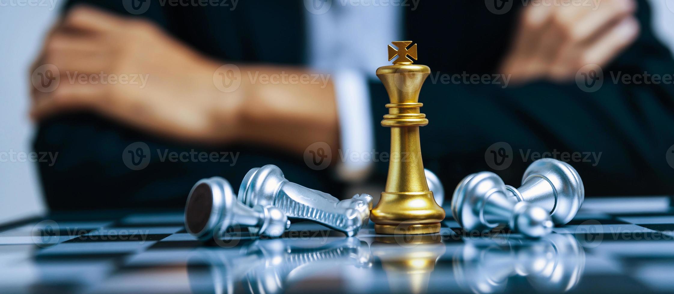 Business strategy. golden king with silver chess piece on chess board game competition on business man background, checkmate, chess battle, victory, success, leadership, teamwork, team leader concept photo