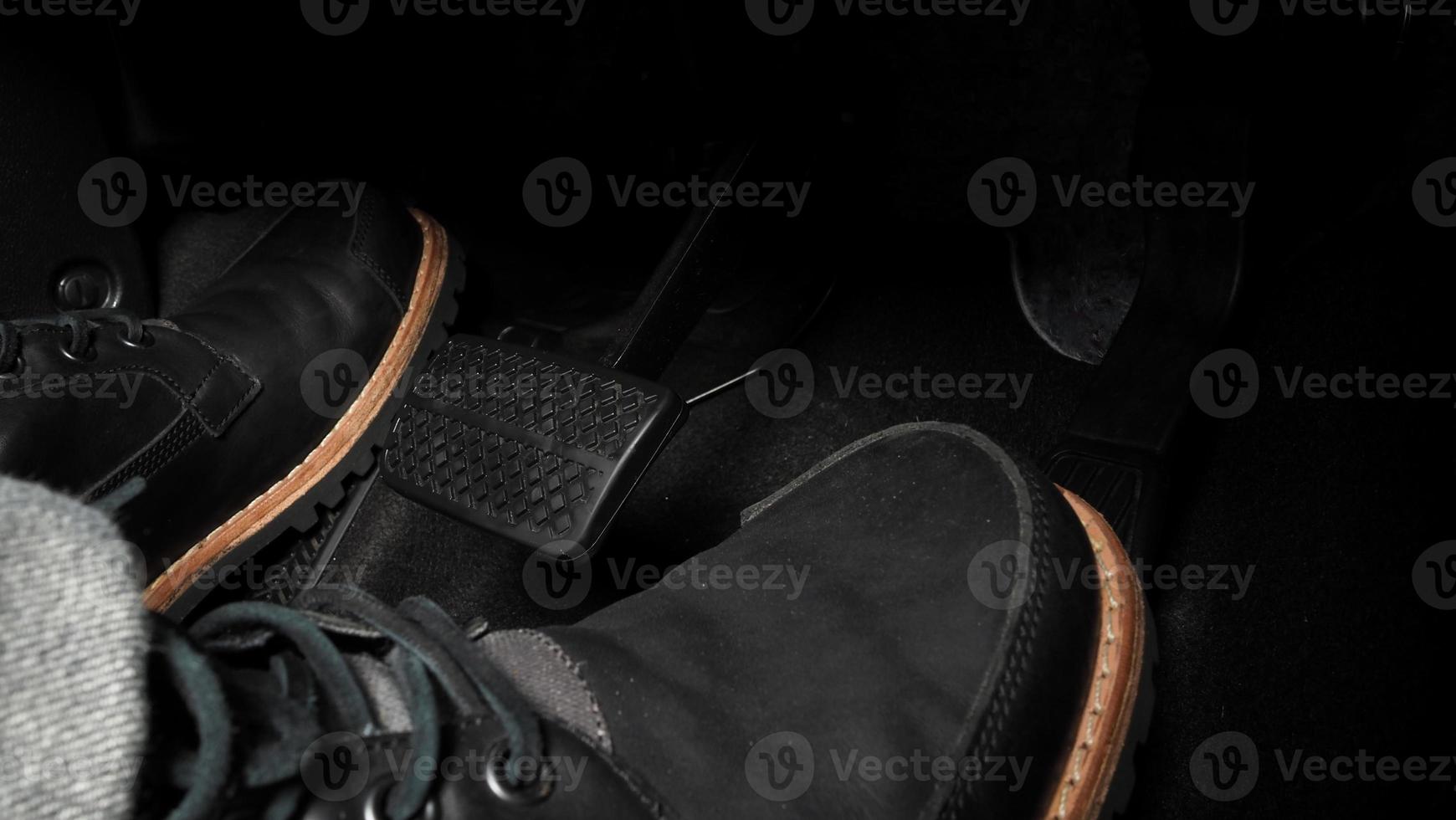 Close up foot press or push foot break and accelerate pedal of a car to drive ahead. photo