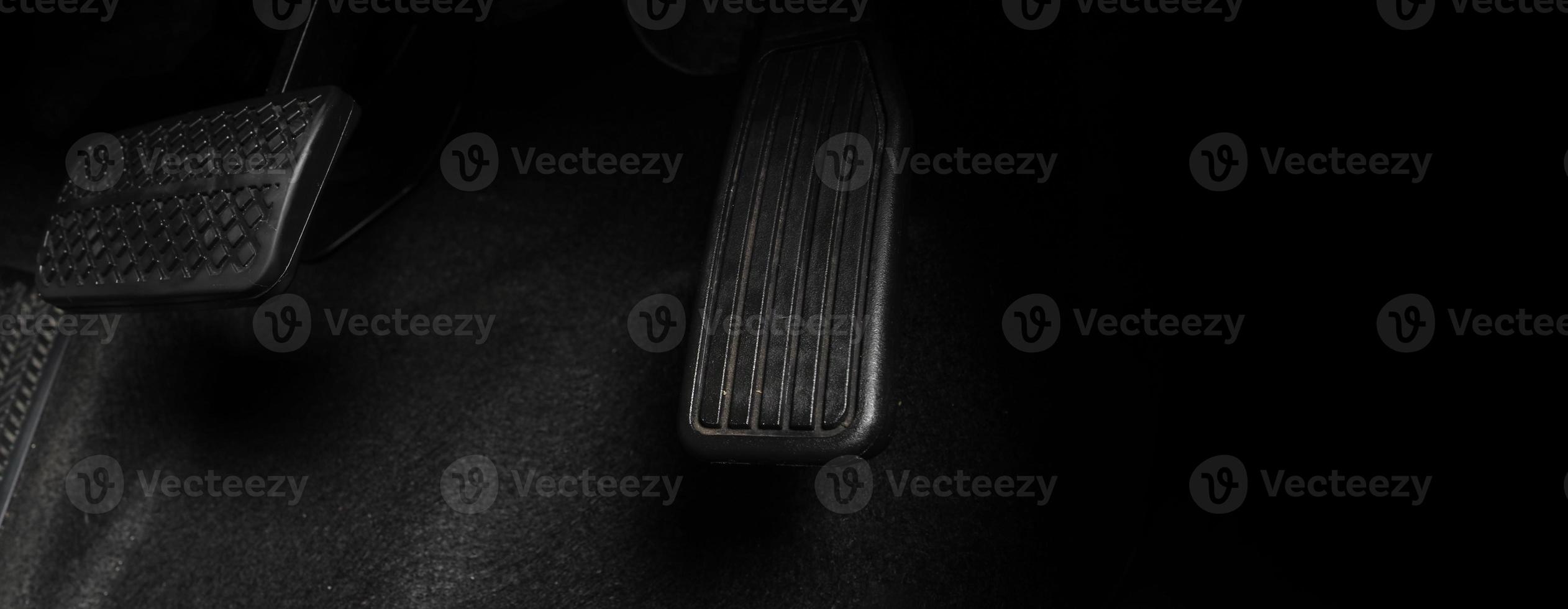 Close up foot press or push foot break and accelerate pedal of a car to drive ahead. photo