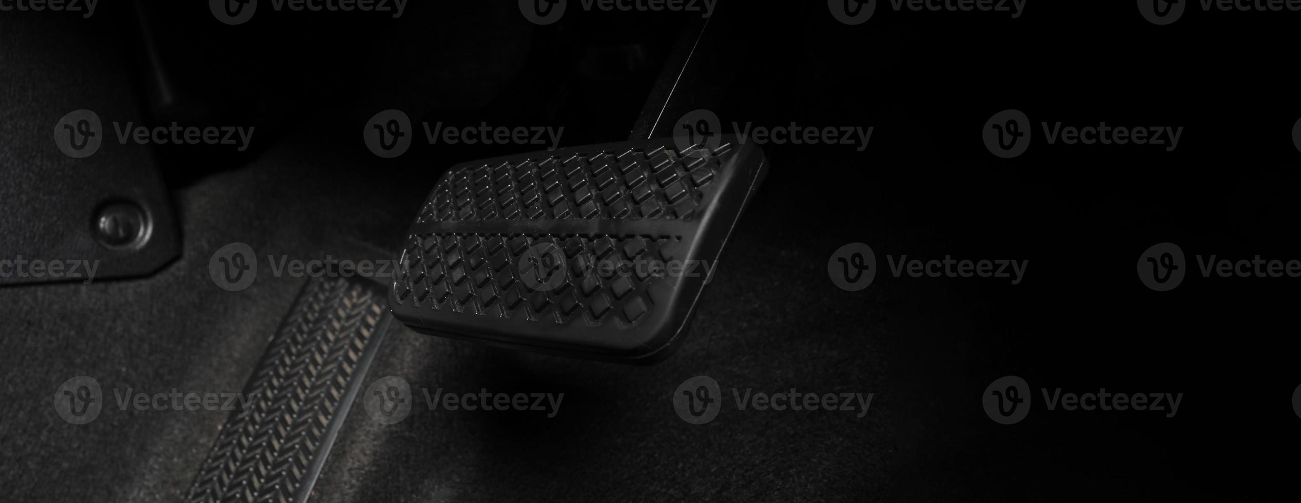 Close up foot press or push foot break and accelerate pedal of a car to drive ahead. photo