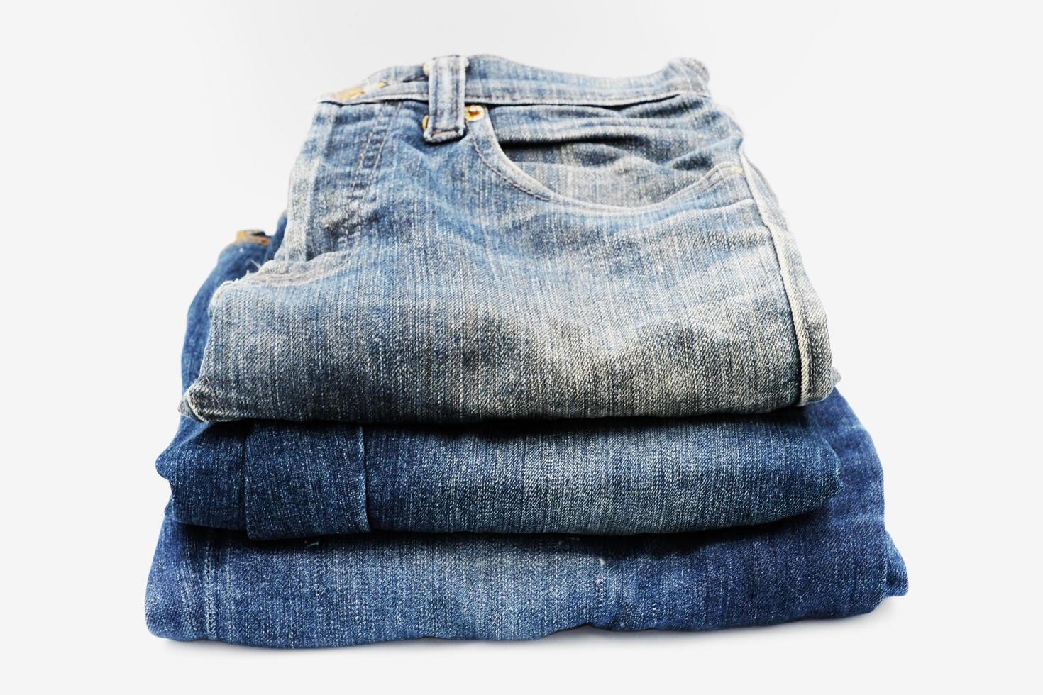 Blue jeans isolated on white background, jeans stacked photo