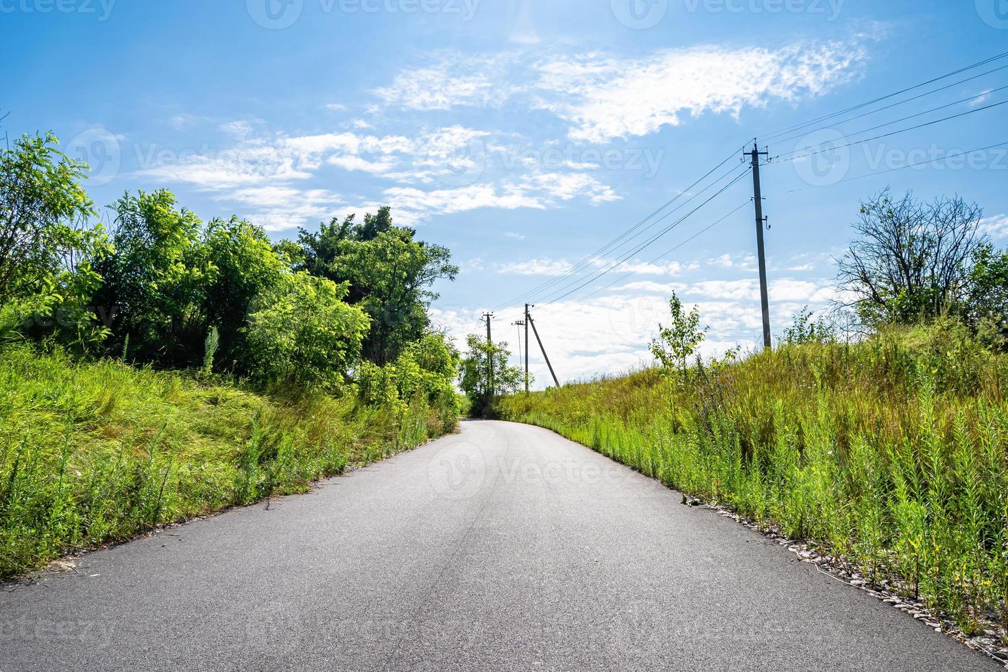 Beautiful empty asphalt road in countryside on colored background photo