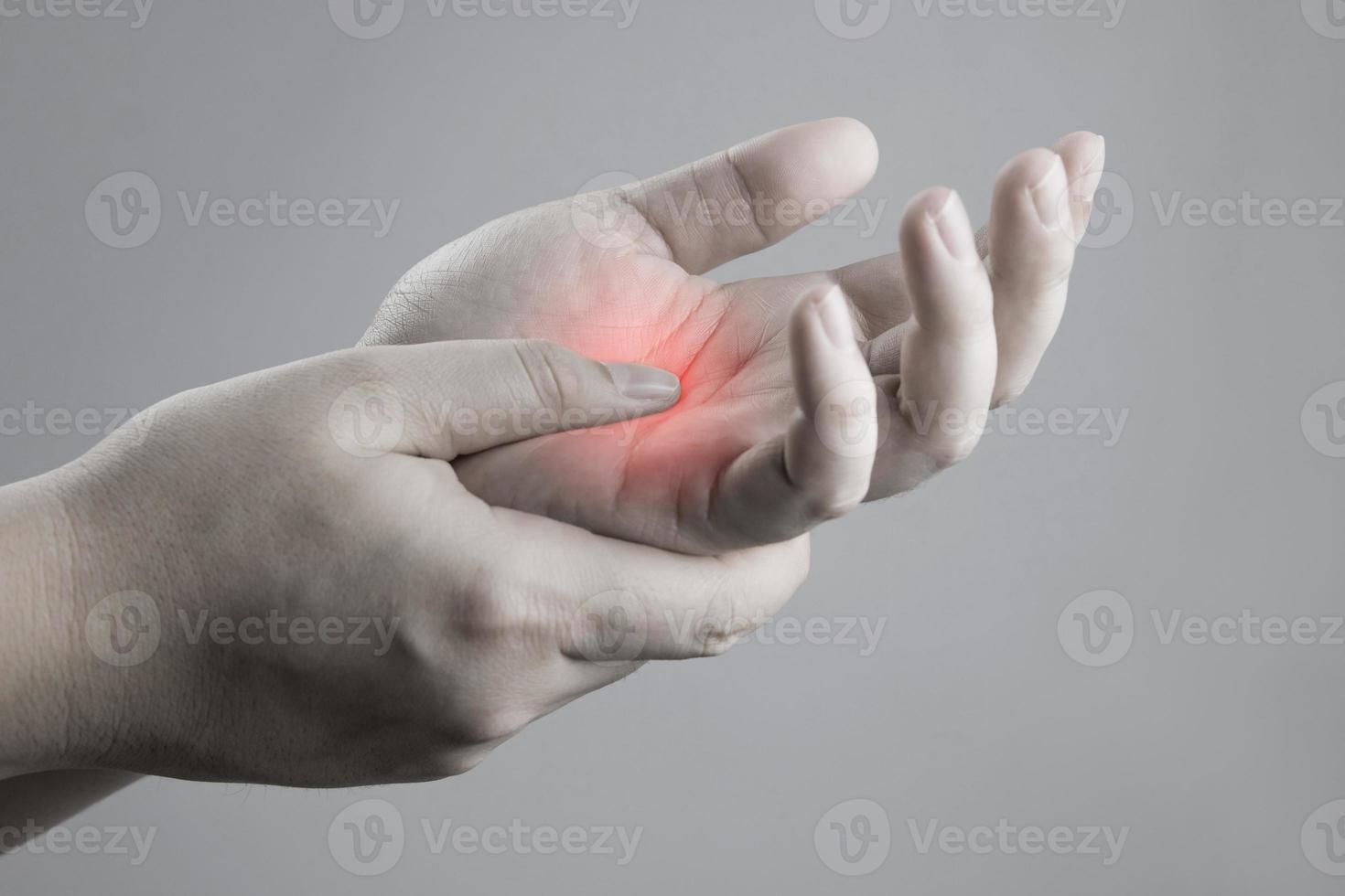 Examination and massage of hands to relieve red palm injuries. health care concept. Fractures of the metacarpal bones, rheumatism, carpal tunnel, Parkinson's disease photo