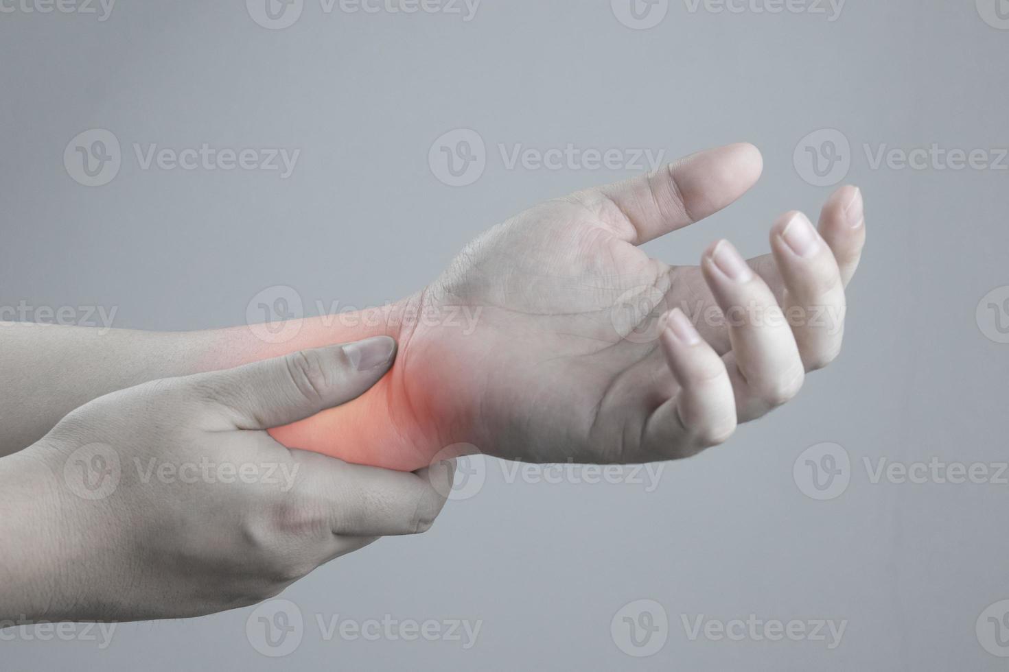 Close up view of male arm holding painful wrist. Health care concept of arm joint injury caused by long hours of work, Carpal Tunnel Syndrome, Rheumatism, Neurological disease. photo