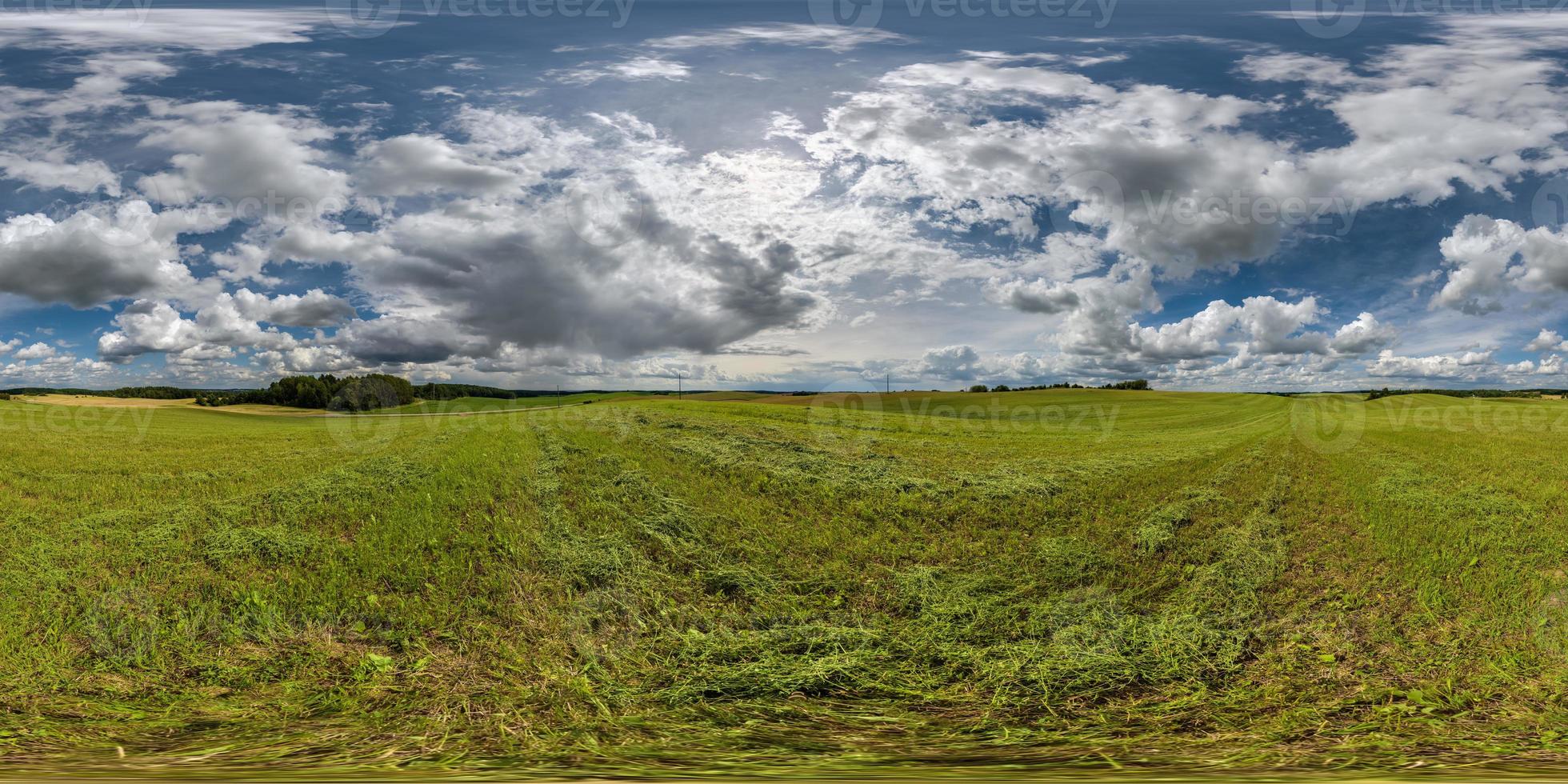 full seamless hdri 360 panorama among farming field with cut grass and clouds in overcast sky in equirectangular spherical projection, ready for use as sky replacement in drone panoramas or VR content photo