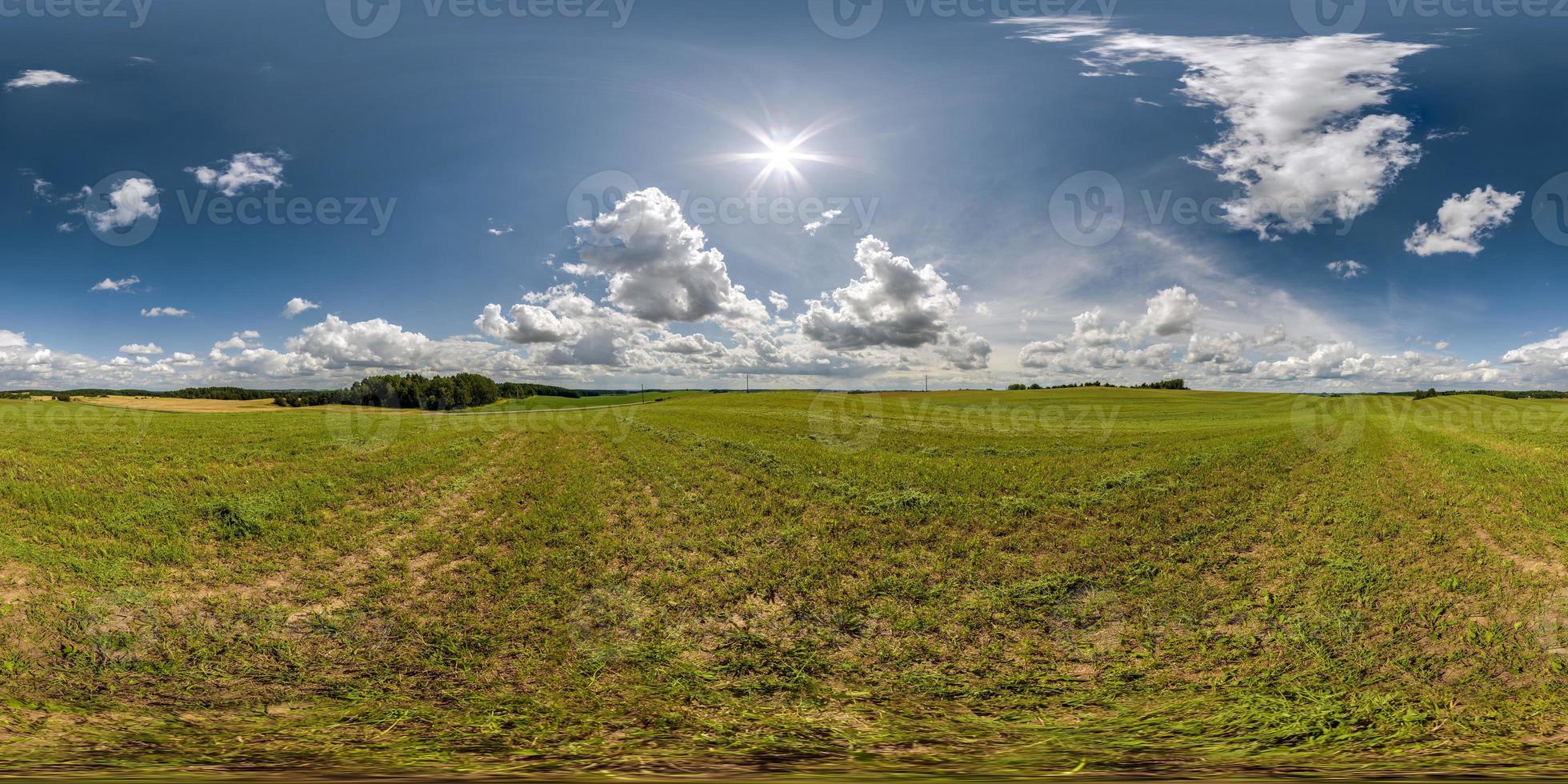 full seamless 360 hdri panorama view among farming field with sun and clouds in overcast sky in equirectangular spherical projection, ready for use as sky replacement in drone panoramas or VR content photo