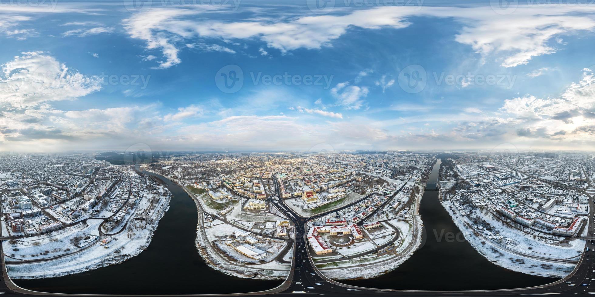 aerial full seamless spherical winter 360 hdri panorama view overlooking old town, urban development, historic buildings, crossroads with bridge across wide river in equirectangular projection photo