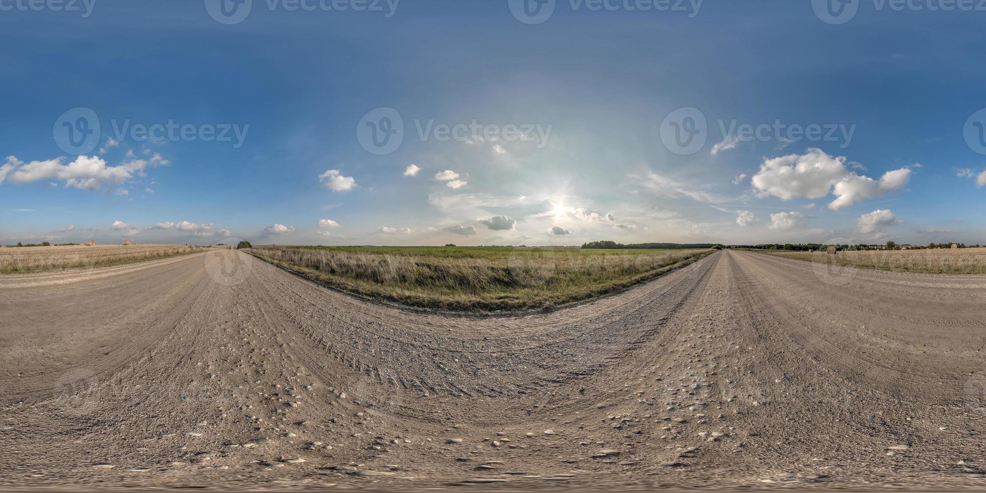 full seamless spherical hdri 360 panorama view on no traffic gravel road among fields with evening sky and white clouds in equirectangular projection,can be used as replacement for sky in panoramas photo