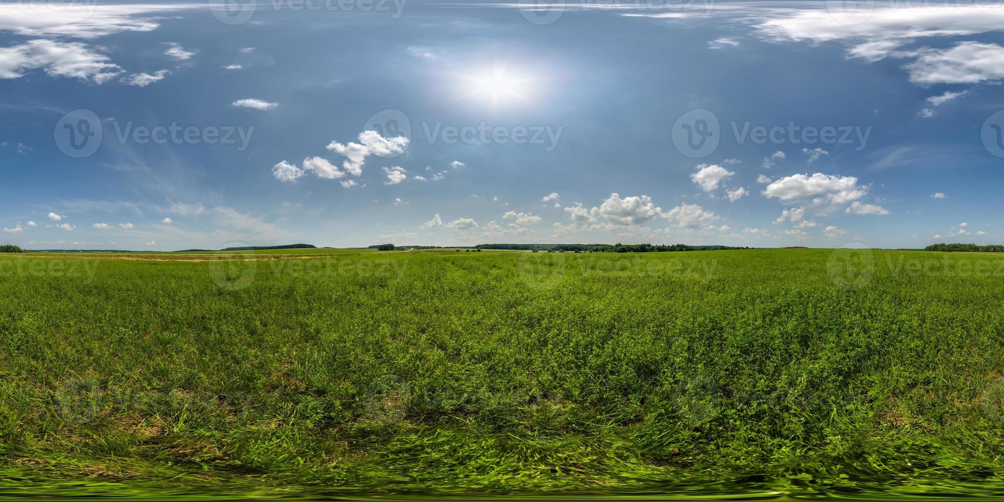 full seamless 360 hdri panorama view among farming field with sun and clouds in overcast sky in equirectangular spherical projection, ready for use as sky replacement in drone panoramas or VR content photo