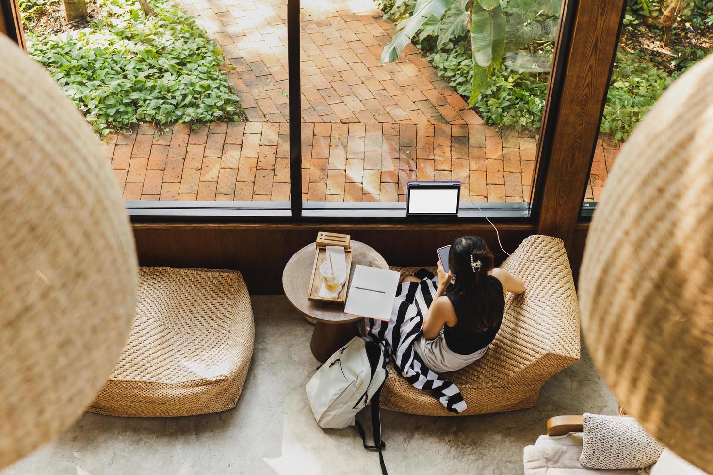 Top view of woman using cellphone in cafe. photo