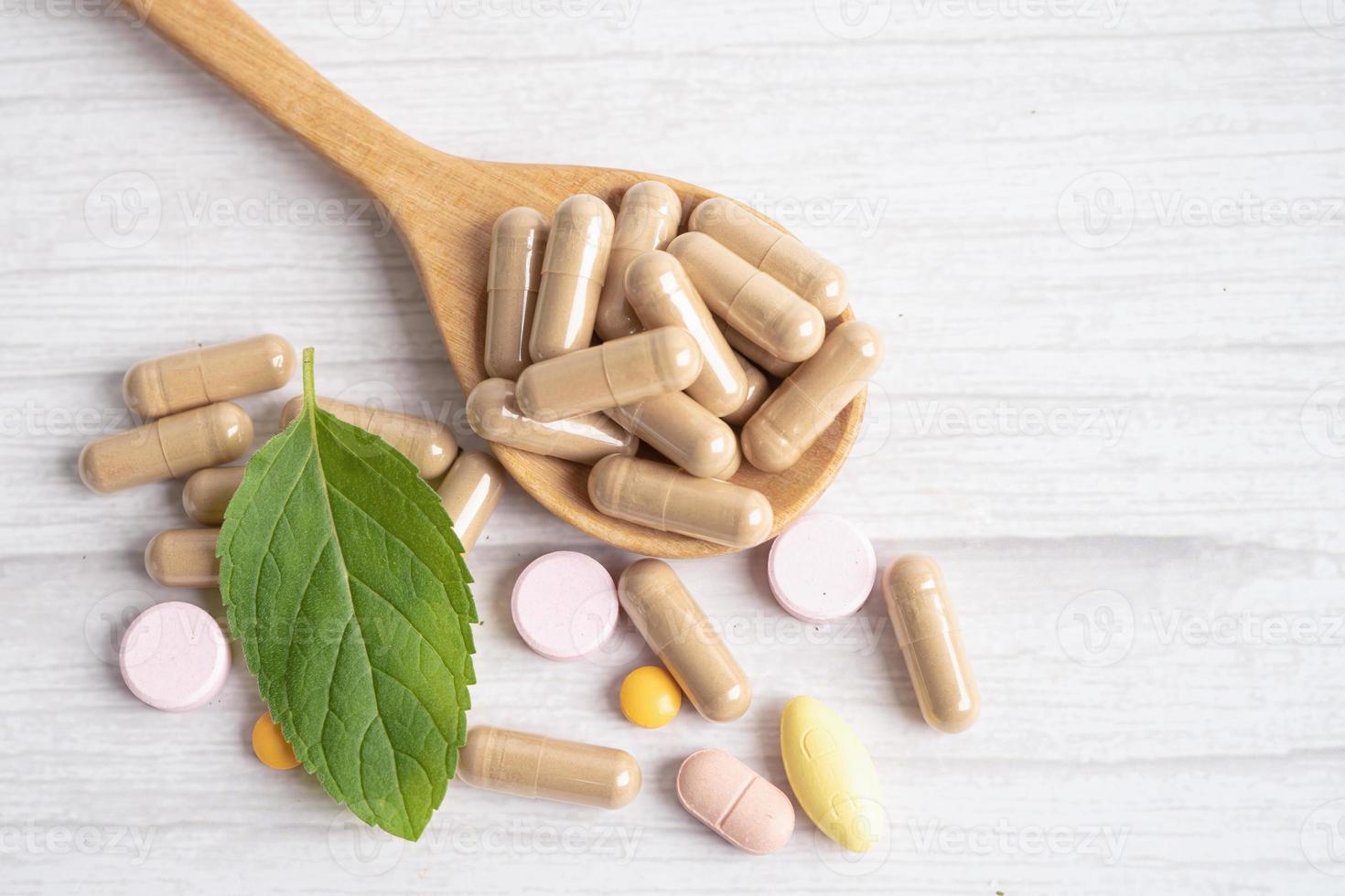 Alternative medicine herbal organic capsule with vitamin E omega 3 fish oil, mineral, drug with herbs leaf natural supplements for healthy good life. photo