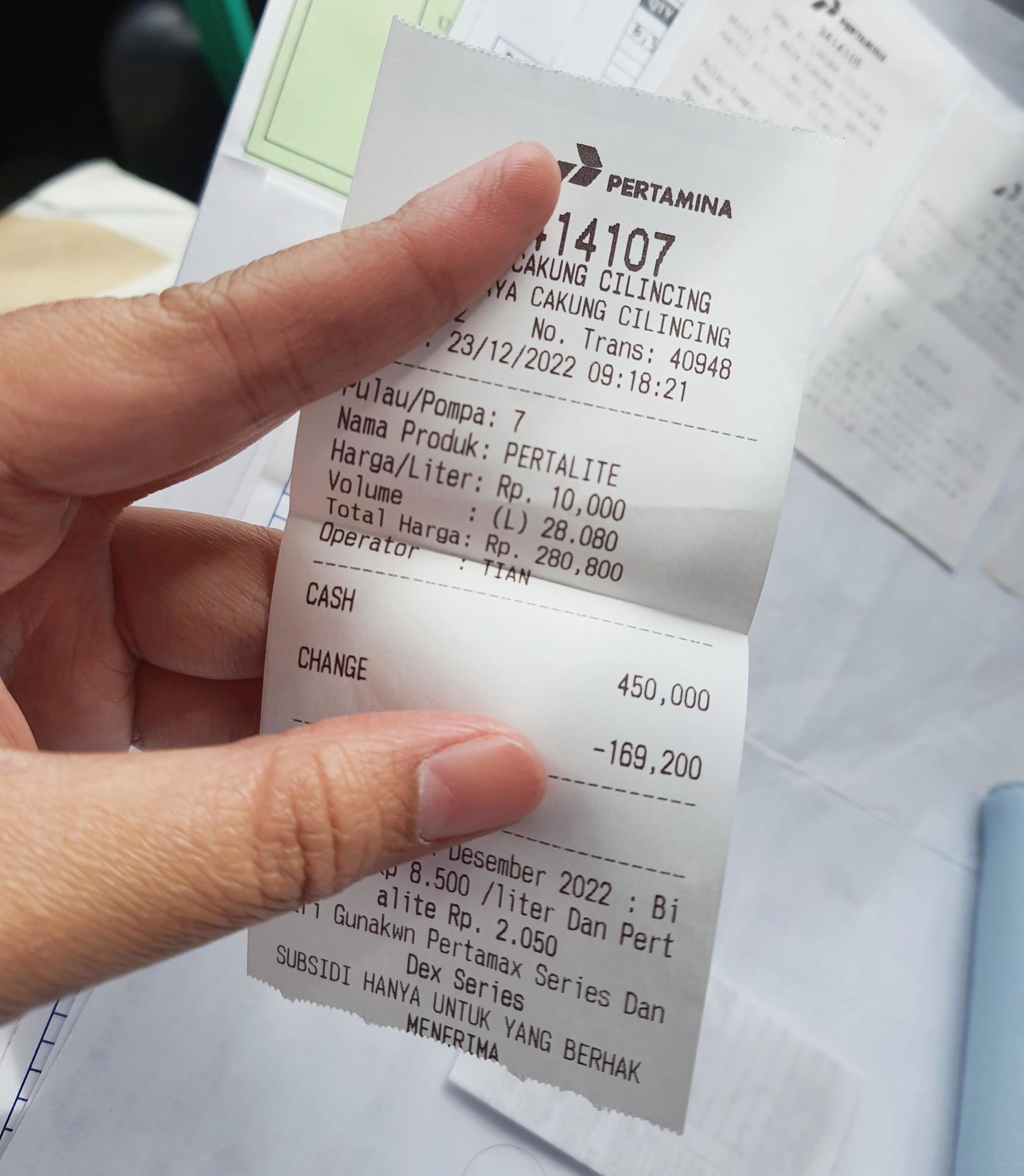West Java, Indonesia in January 2023. A hand is holding a fuel purchase
