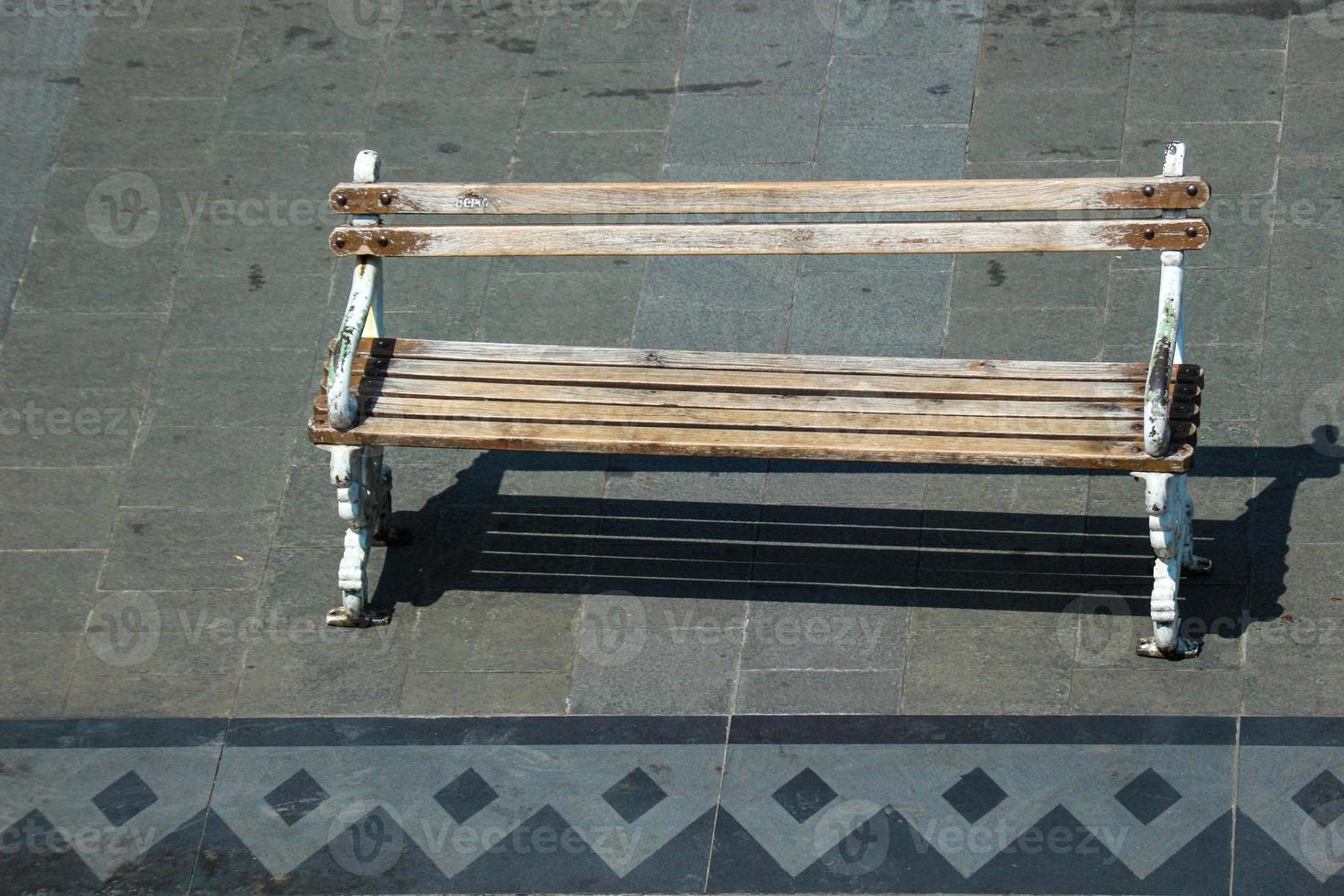 A wooden chair on the side of the road, photo