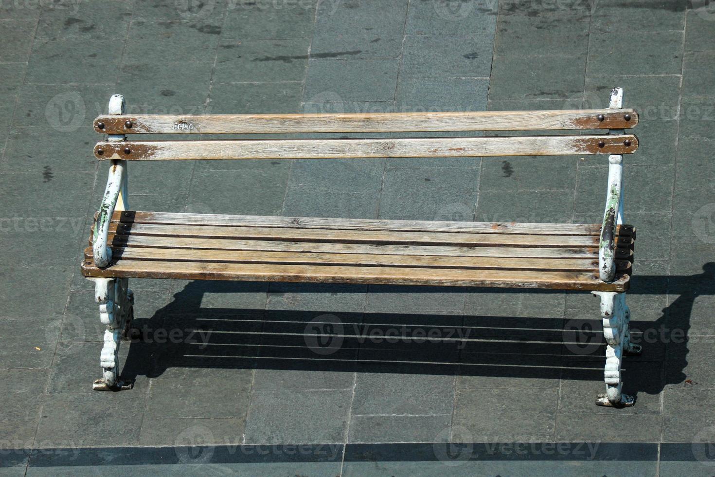 A wooden chair on the side of the road, photo