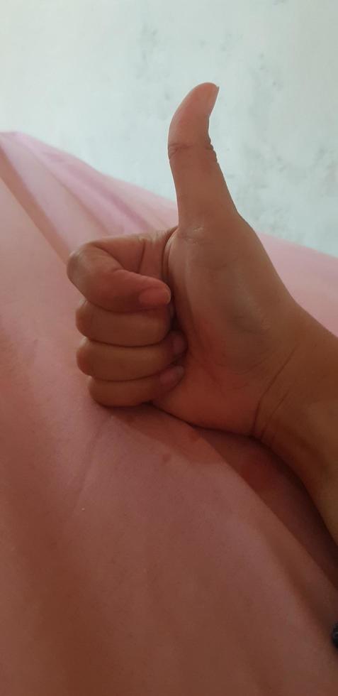 A hand giving a thumbs up. photo