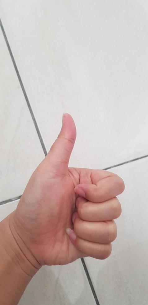 A hand giving a thumbs up. photo