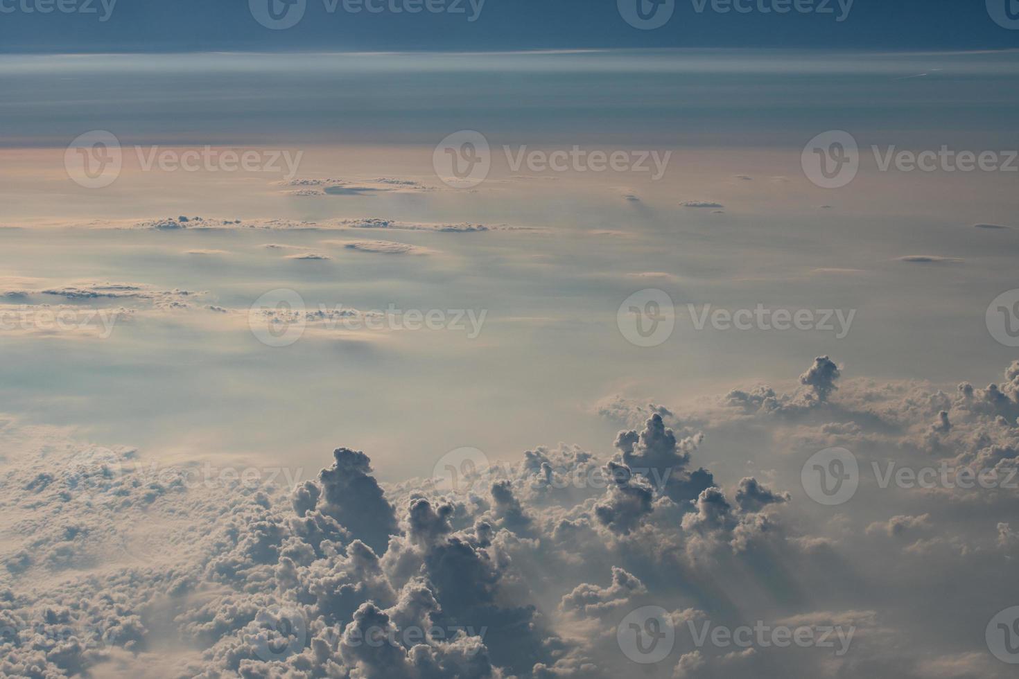 beautiful fluffy clouds from the window of the plane photo