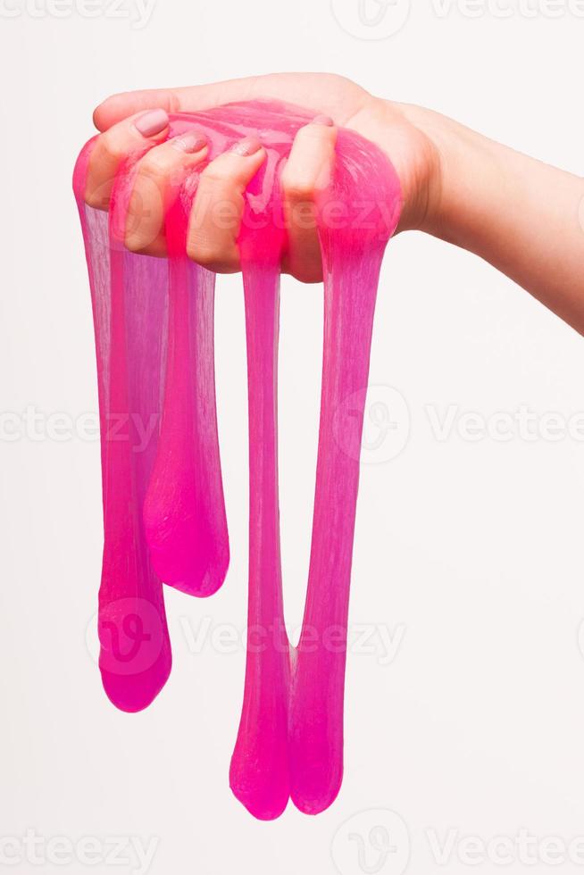 a toy for children mucus and liquid flowing on hand on a white background photo