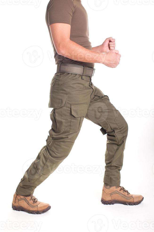 A fighter in military uniform is ready for a fight on a white background photo