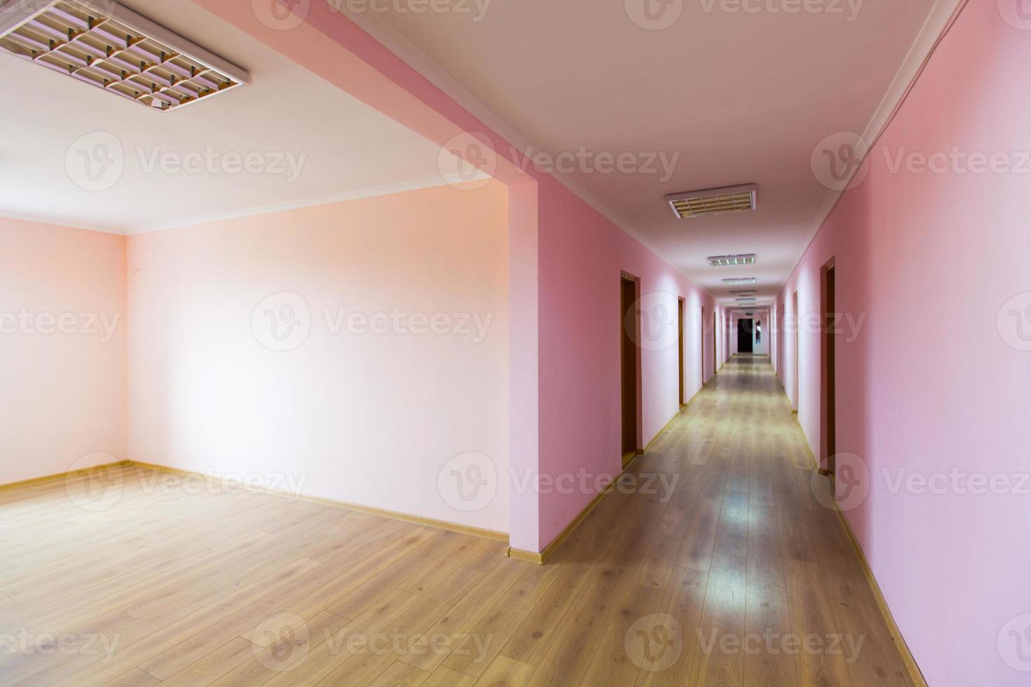 perspective of the empty corridor with many doors photo