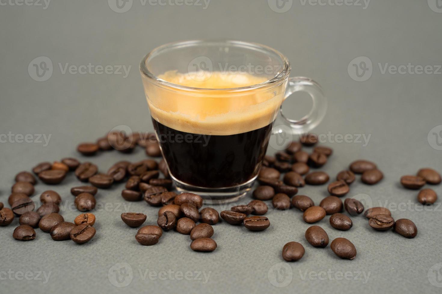 close up of a mug of coffee scattered coffee beans photo