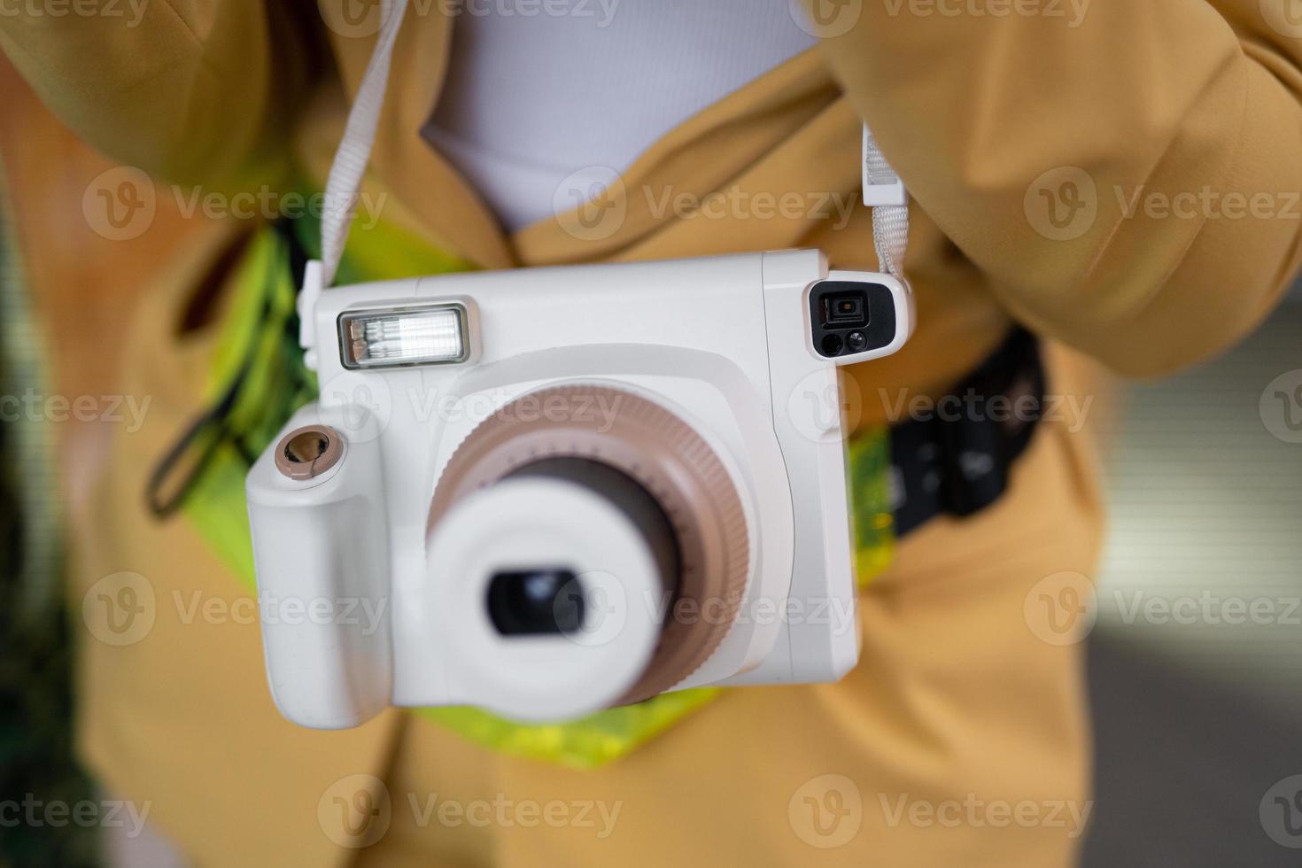 a modern fashionable film camera that takes instant photos. photo