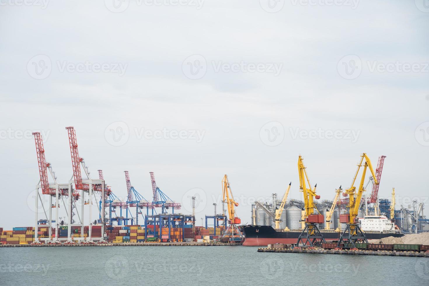 seaport where large cranes are loaded containers on cargo ships photo